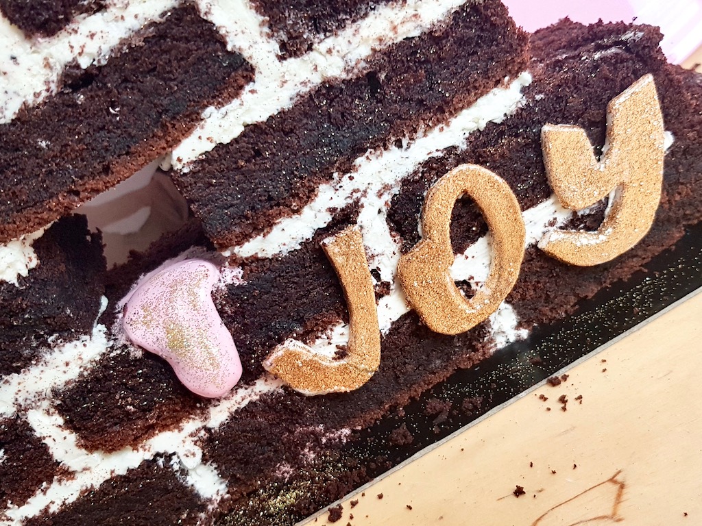 Beer chocolate cake built as a wall Joy inscription detail
