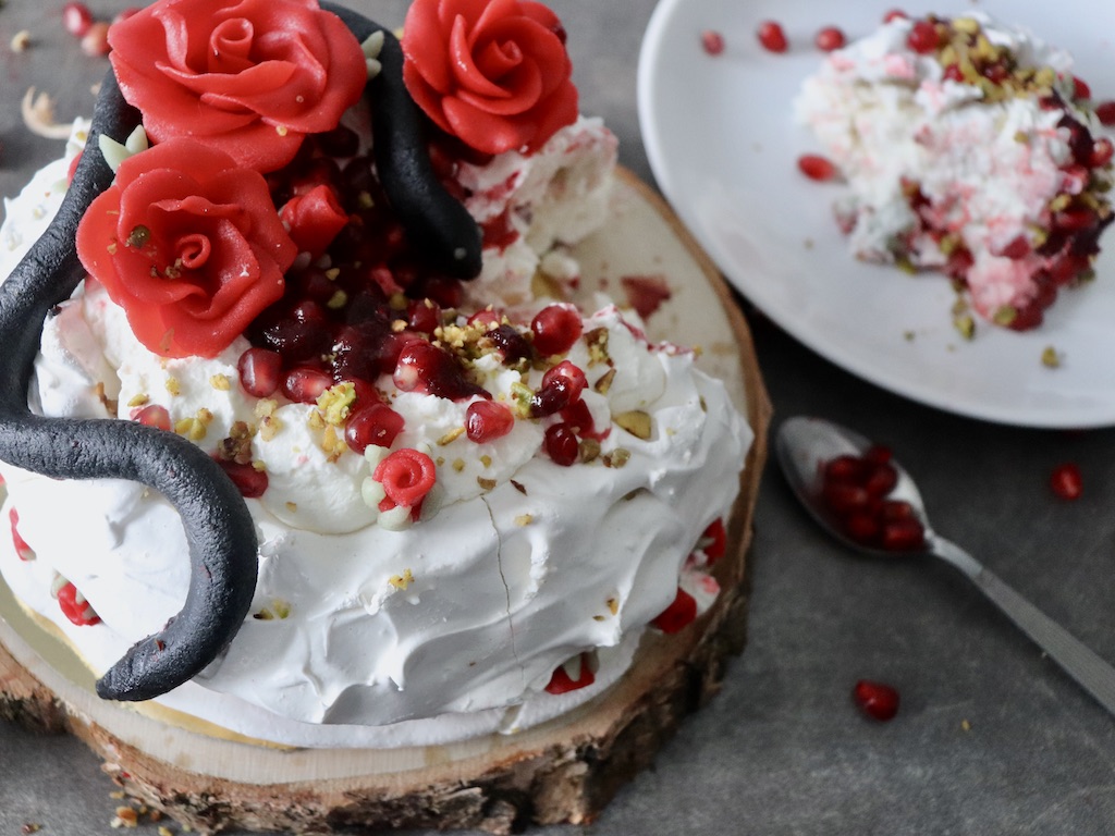 Pavlova with marzipan snake and roses on top