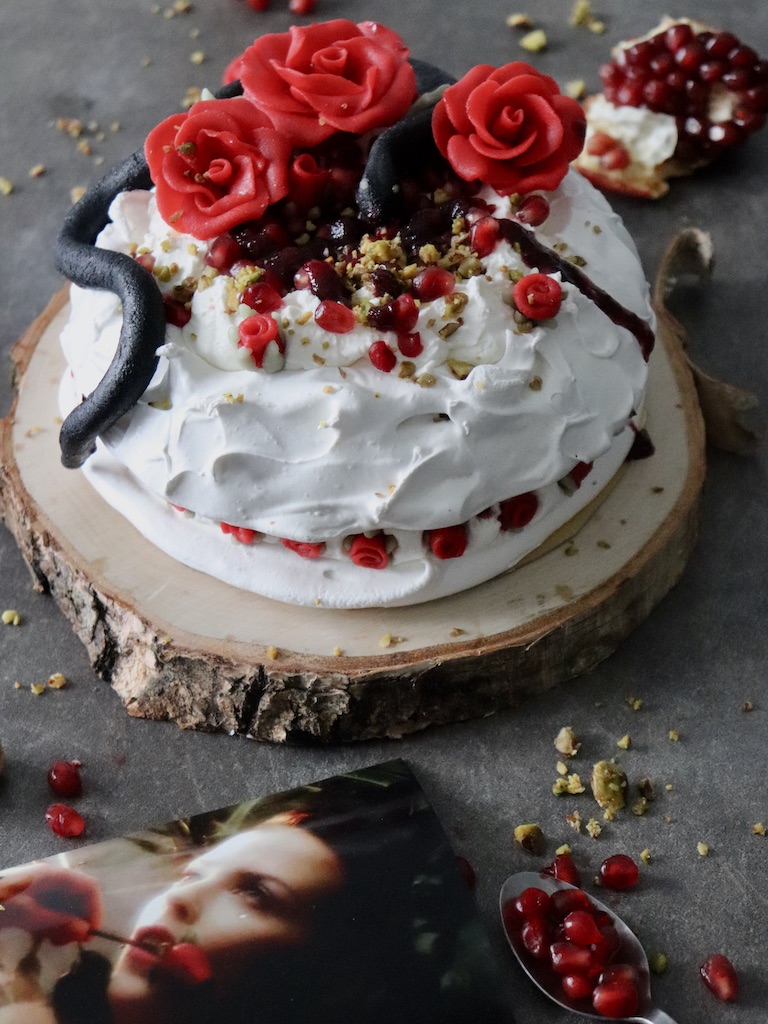 Pavlova with pomegranate snake and marzipan roses