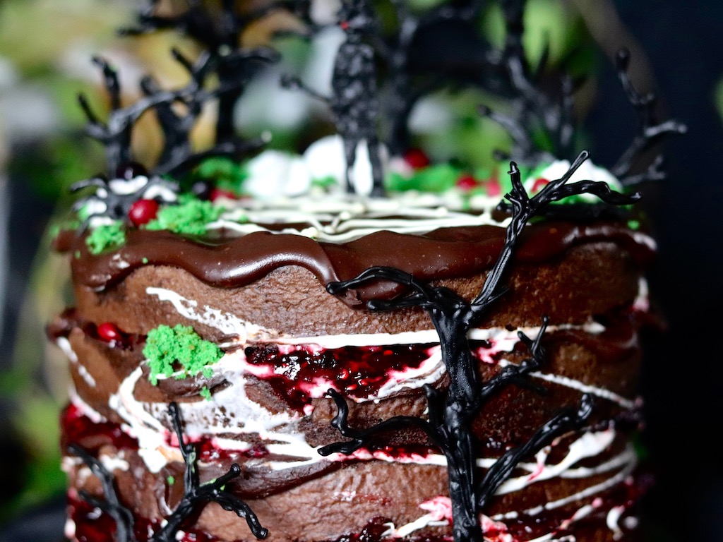 Chocolate layer cake filled with red berries detail