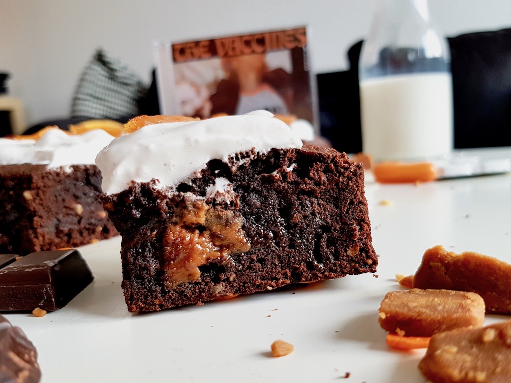 Slice of chocolate fudge brownie covered with marshmallow