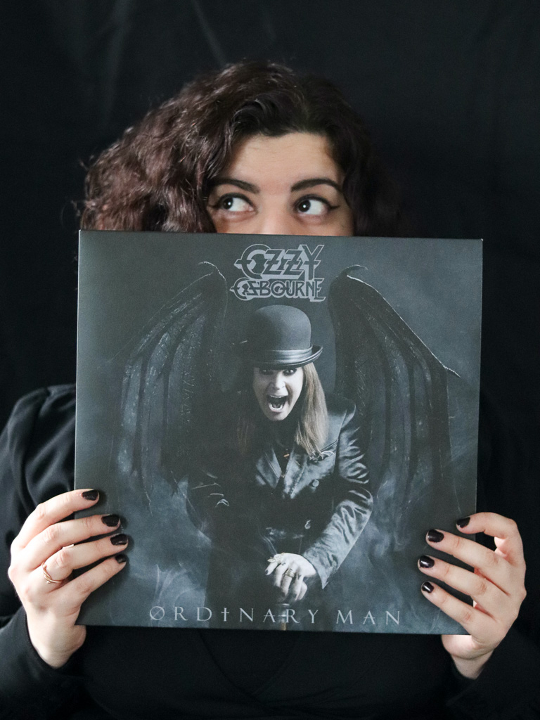Girl hoding Ozzy Osbourne vinyl record