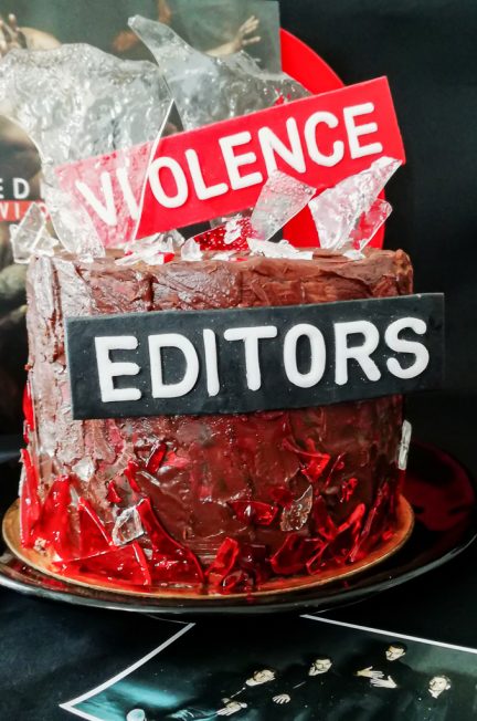 Chocolate layer cake with edible glass next to Editors Violence vinyl record