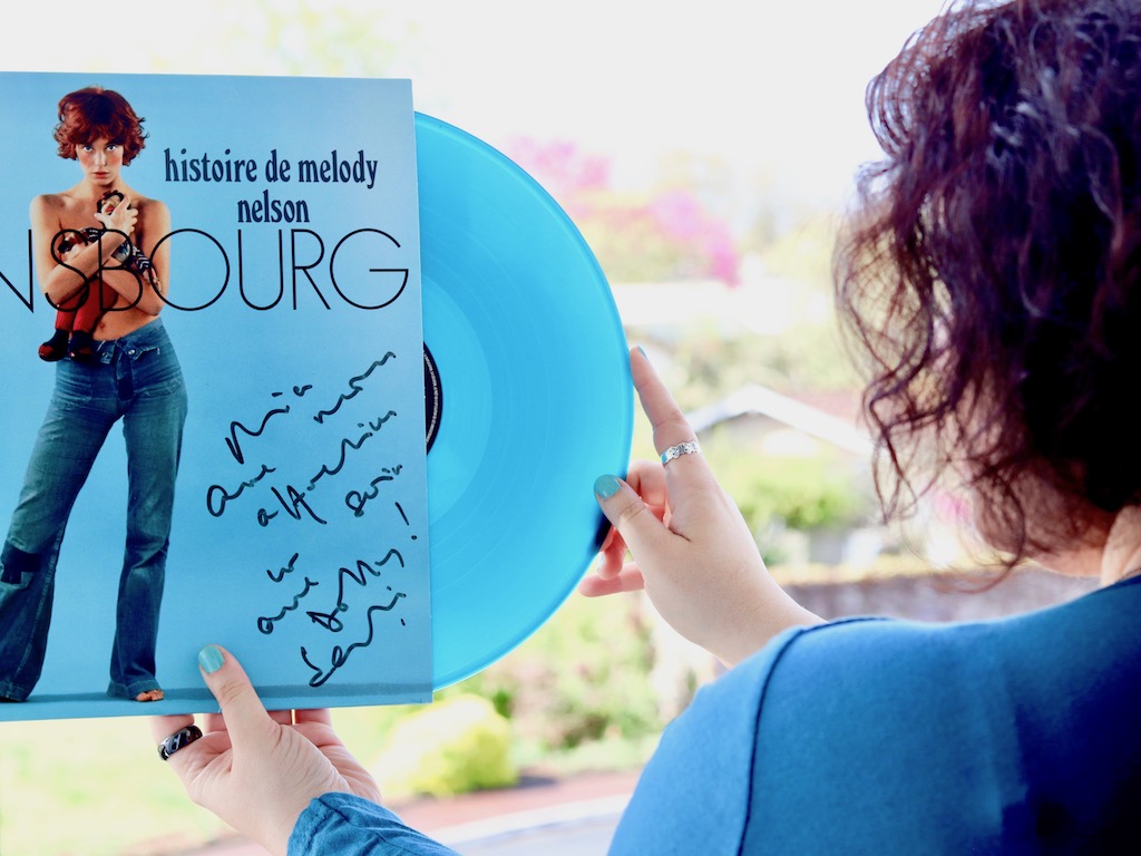 Girl holding Gainsbourg Melody Nelson blue vinyl signed by Jane Birkin