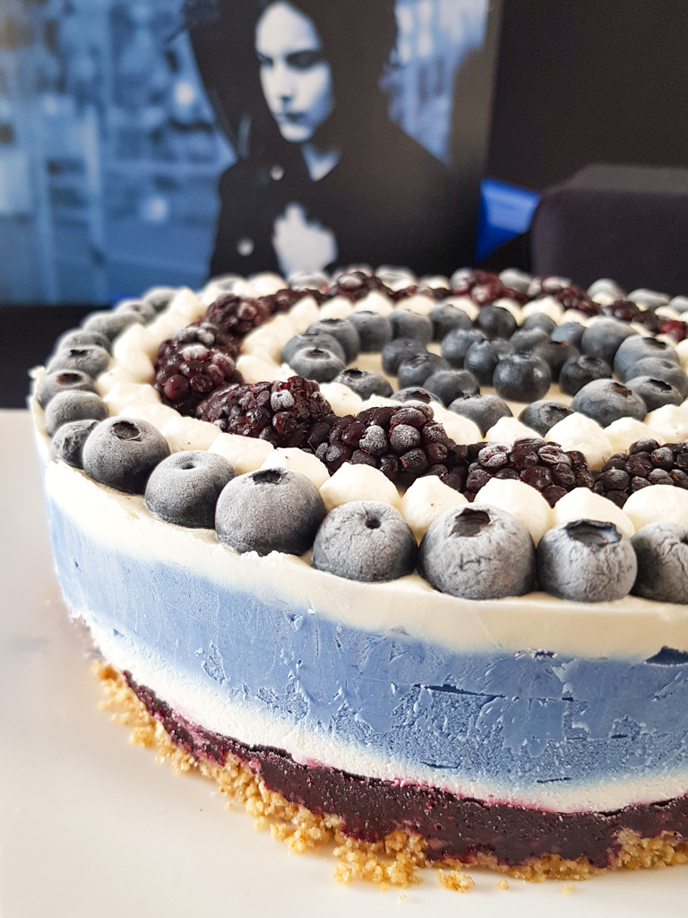 Graphic blue and white cheesecake topped with blueberries and blackberries next to Jack White Blunderbuss vinyl