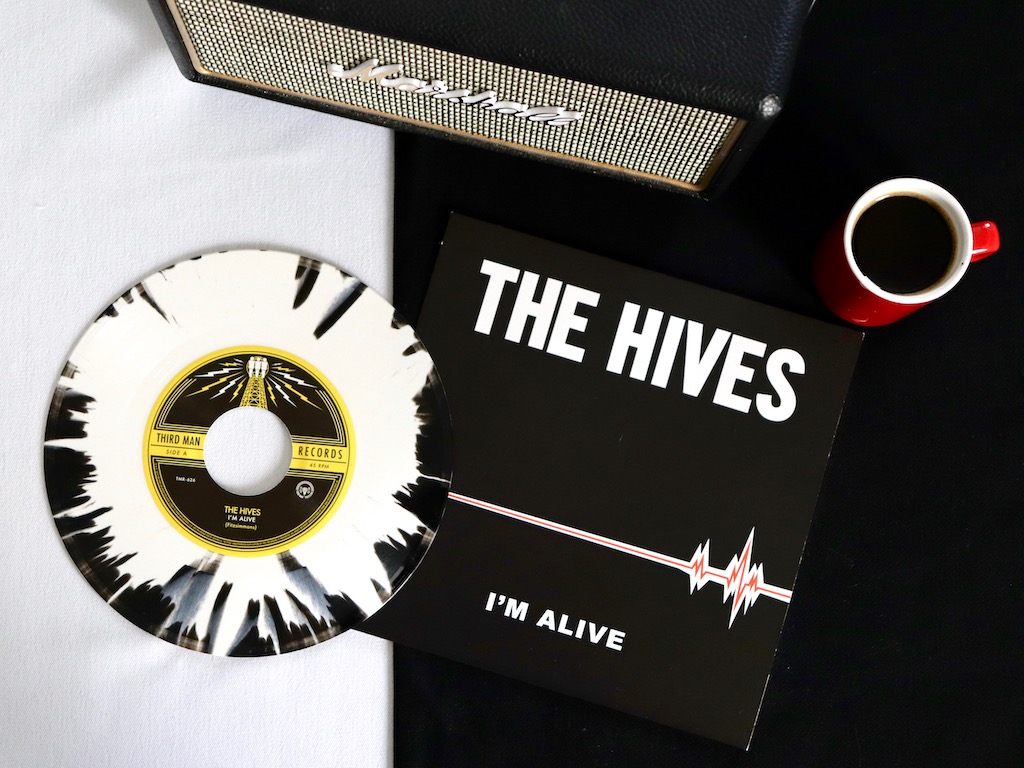 The Hives Im Alive splattered black and white vinyl with cup of coffee and Marshall amp