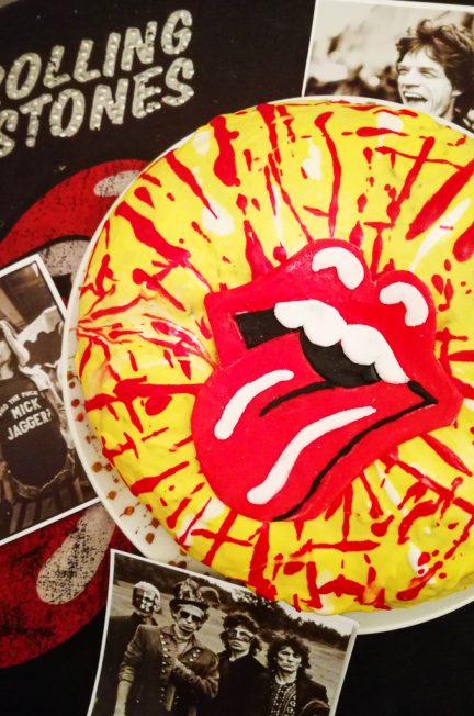 Red and yellow king cake decorated with The Rolling Stones signature tongue in sugar paste