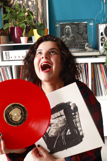 Girl holding Iggy Pop red vinyl