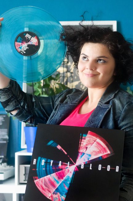 Girl showing Royal Blood's Typhoons vinyl