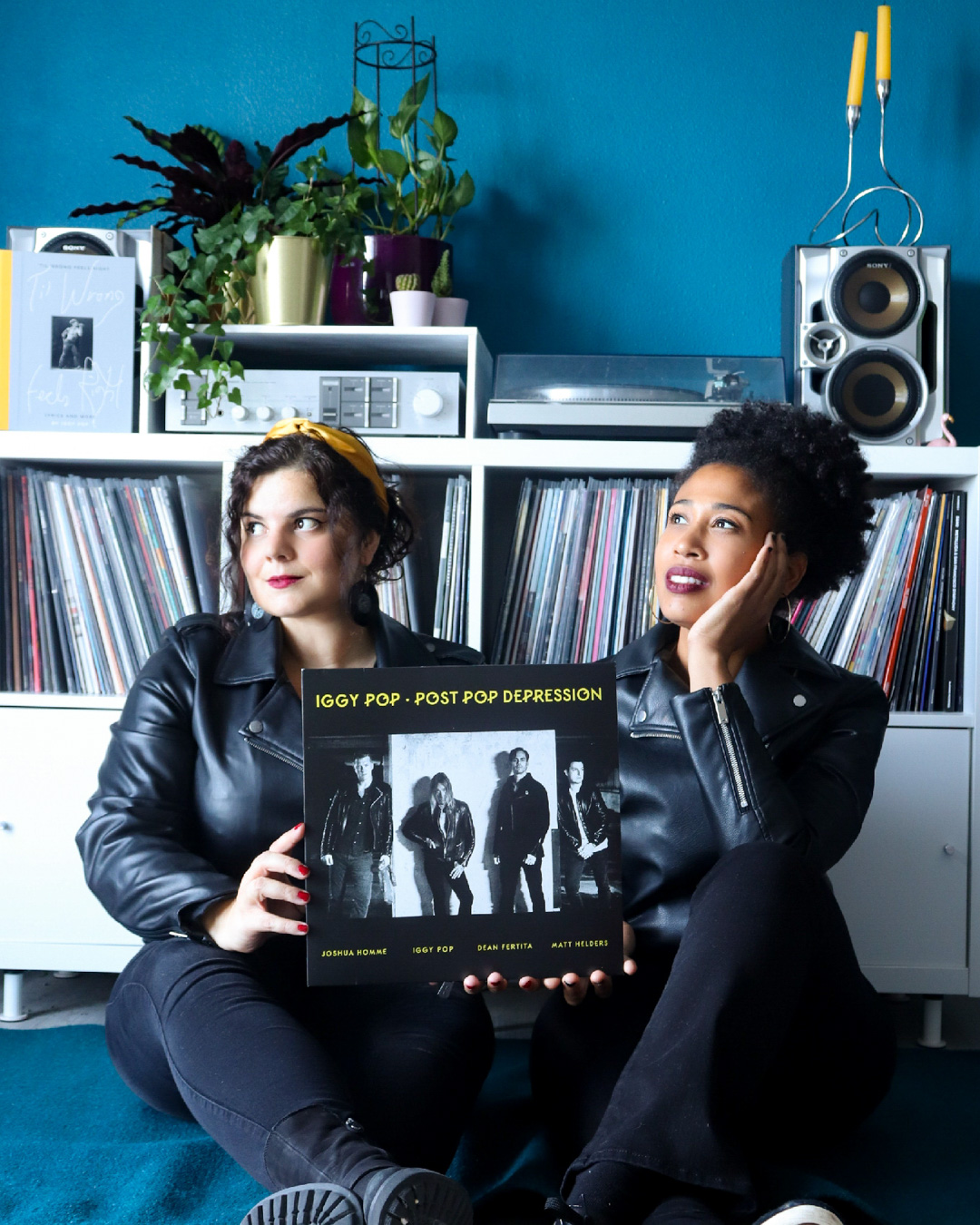 2 girls holding Post Pop Depression vinyl