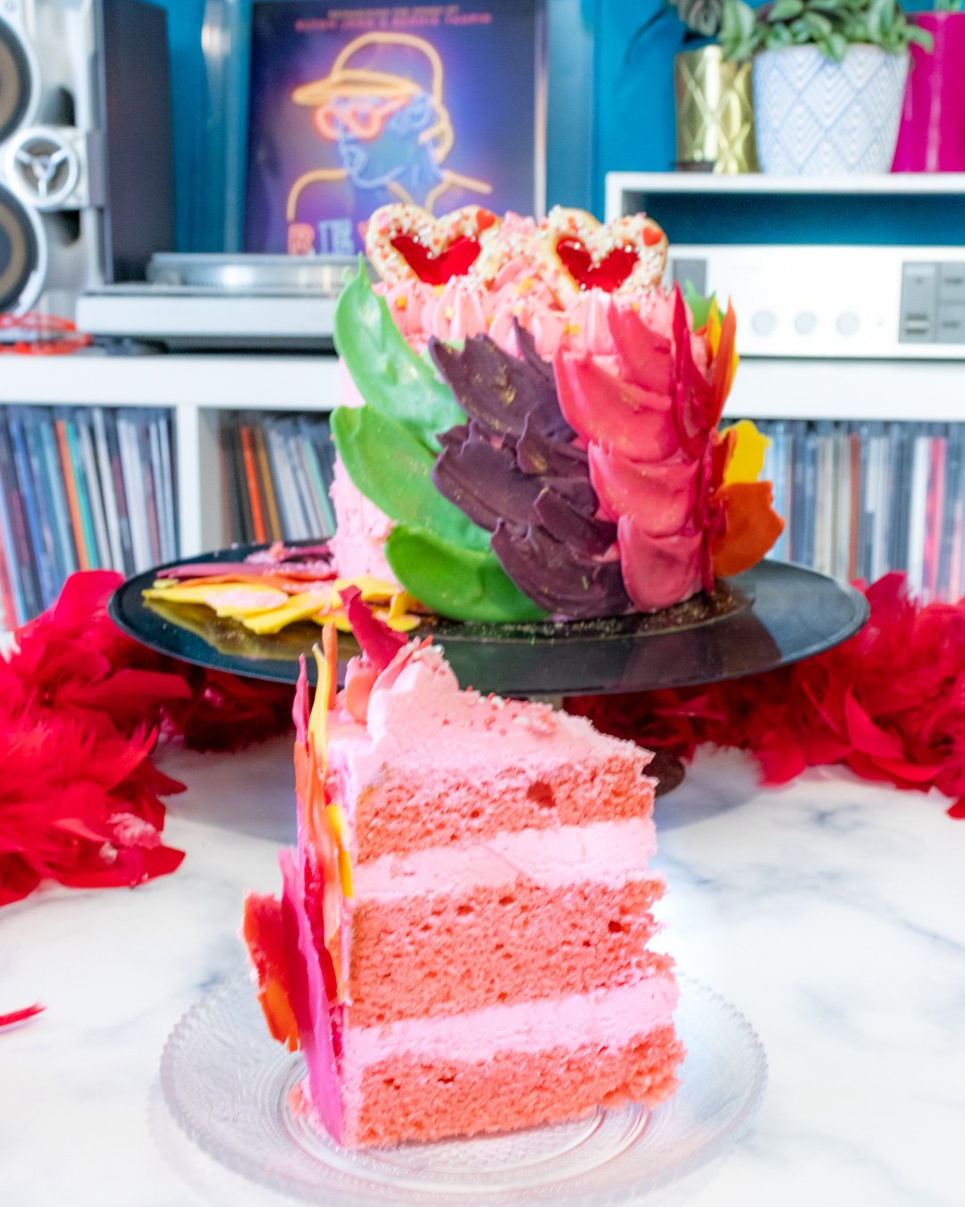 Elton John inspired rainbow cake covered with chocolate feathers