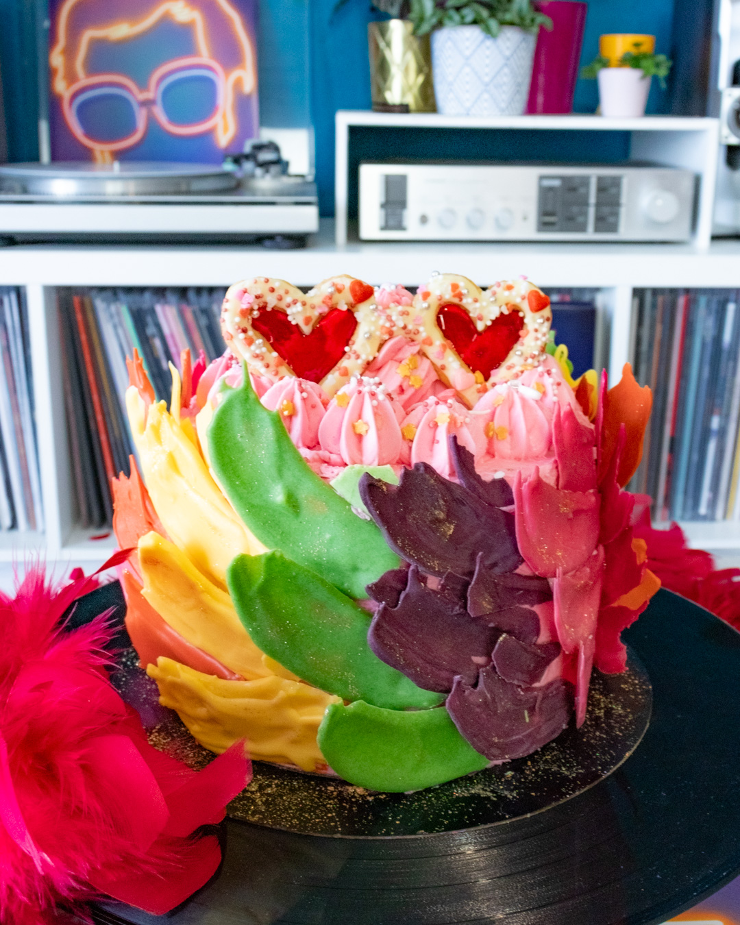 Elton John inspired rainbow cake covered with chocolate feathers