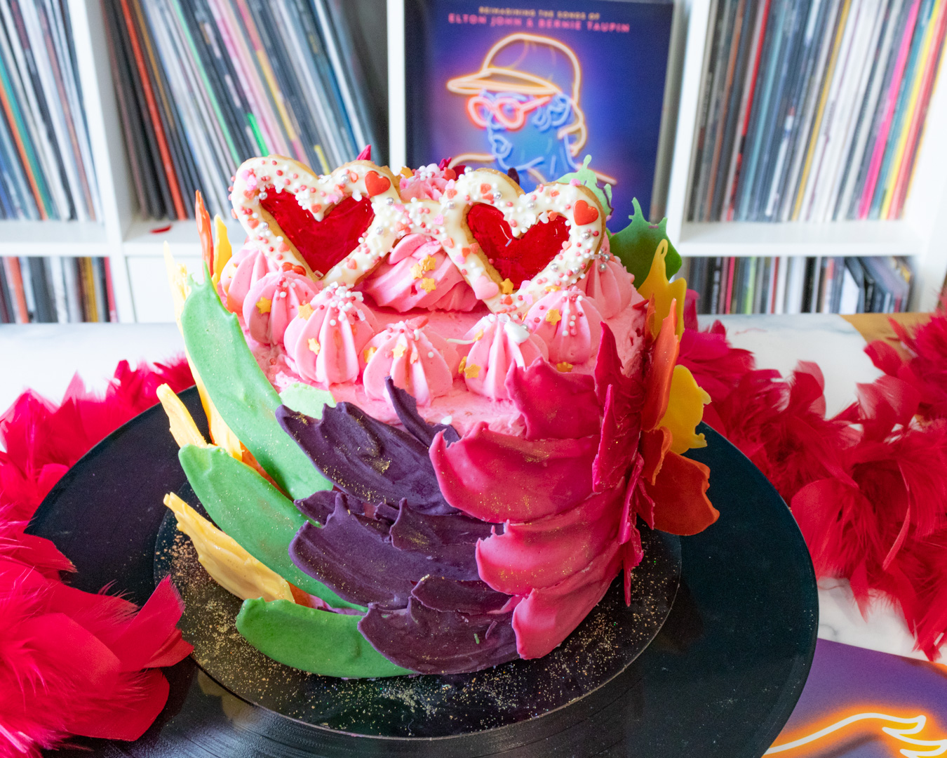 Elton John inspired rainbow cake covered with chocolate feathers