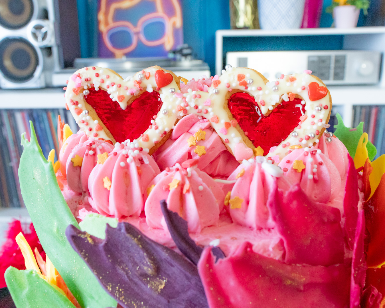 Elton John inspired rainbow cake covered with chocolate feathers