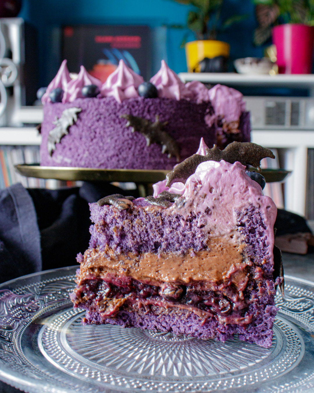 Slice of Black Sabbath inspired purple cake with chocolate and blueberries