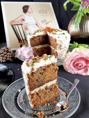 Slice of vegan layer carrot cake with pecan and pistacchio next to Alela Diane Cusp vinyl record