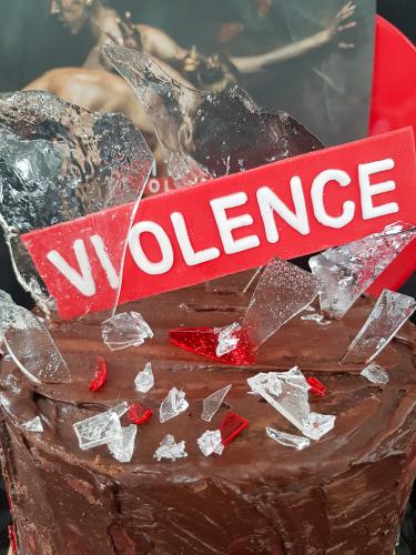 Chocolate layer cake view from top with edible glass next to Editors Violence vinyl record