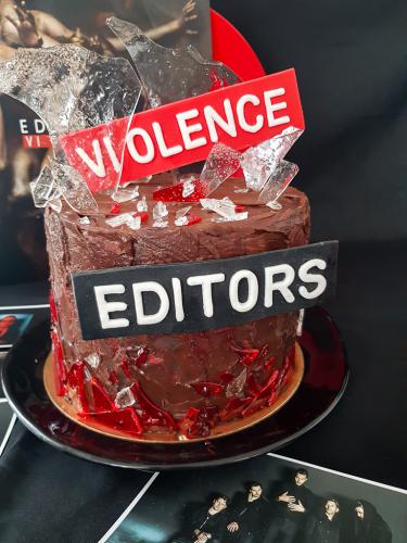 Chocolate layer cake with edible glass next to Editors Violence vinyl record