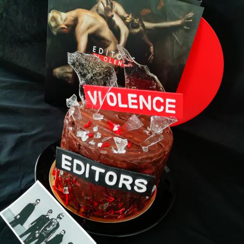 Chocolate layer cake with edible glass next to Editors Violence vinyl record