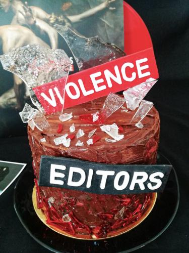 Chocolate layer cake with edible glass next to Editors Violence vinyl record