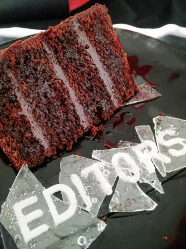 Slice of chocolate layer cake with edible glass and sugar paste letters