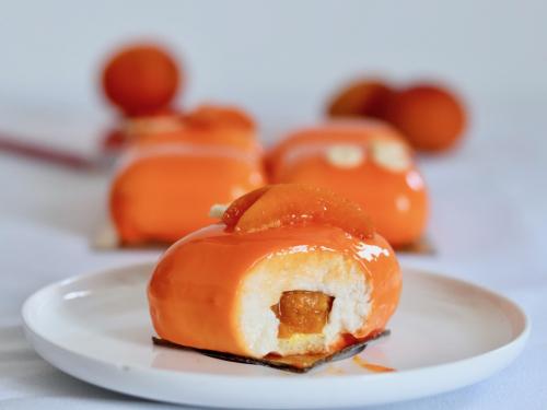 Apricot entremet with orange mirror glaze cut