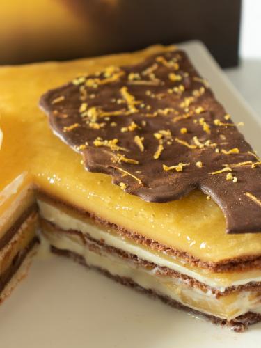 Lemon opera cake cut with chocolate face