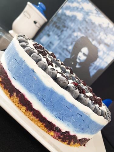 Graphic blue and white cheesecake topped with blueberries and blackberries next to Jack White Blunderbuss vinyl