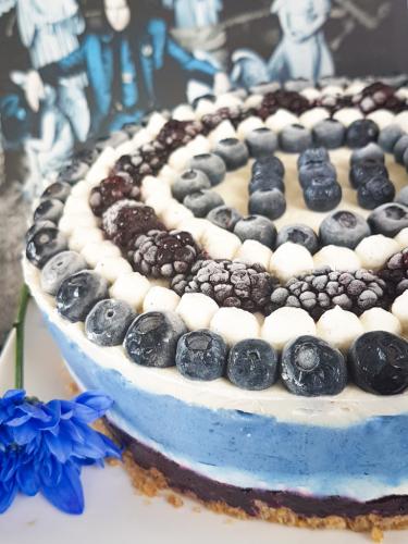 Graphic blue and white cheesecake topped with blueberries and blackberries next to Jack White Lazaretto vinyl