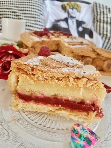 Galette des rois slice close up puff pastry generous frangipane cream and raspberry cream