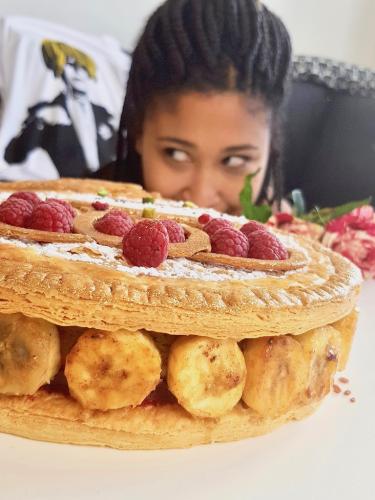 Girl looking at galette des rois puff pastry detail filled with caramelized bananas