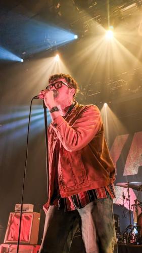 James Smith on stage with Yard Act