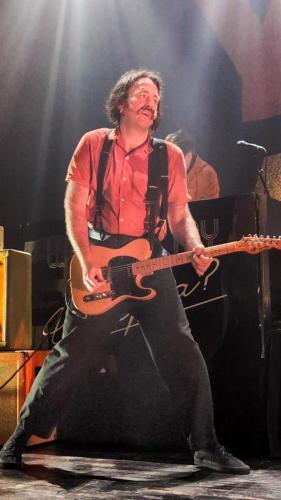 Sam Shipstone on stage with Yard Act