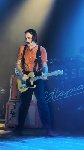 Sam Shipstone on stage with Yard Act